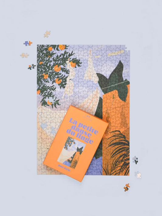 Illustration du puzzle La petite danse du linge avec drap blanc, terrasse et ciel couchant