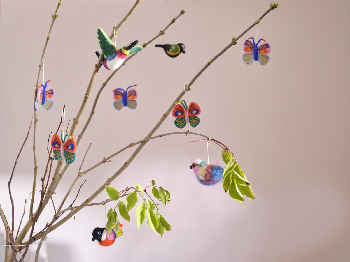 Décorations en laine Aveva suspendues en situation, avec le modèle Oiseau vert mousse