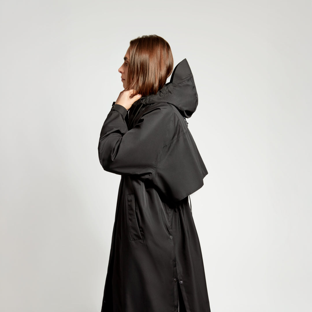 Trench Fudoon noir porté de profil, détail de la capuche